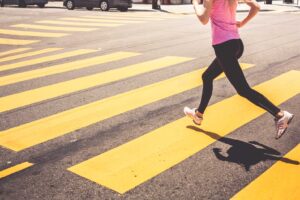 Blonde Woman Running Over The Pedestrian Crossing