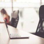 Laptop on Wooden Desk in Office Open Space