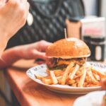 Woman Preparing to Eat Big Bacon Burger