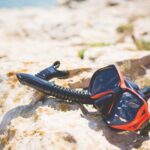 Snorkel and Diving Scuba Mask On a Rock Near The Sea
